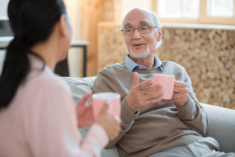 Elderly client receiving in-home care consultation in Brisbane